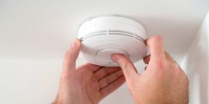 Smart smoke and carbon monoxide detector on a ceiling
