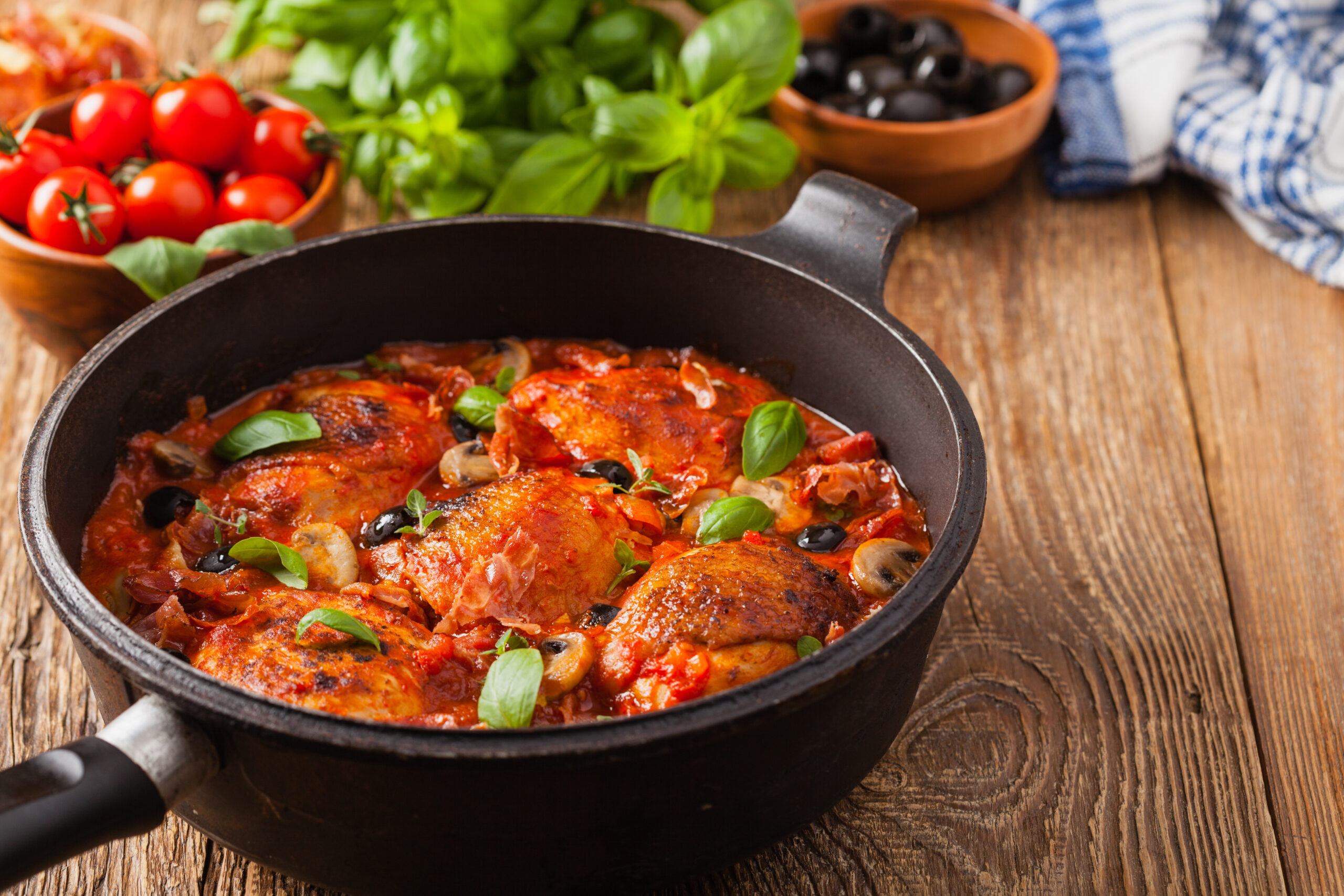 Chicken cacciatore with tomatoes, bell peppers, and onions in a pot