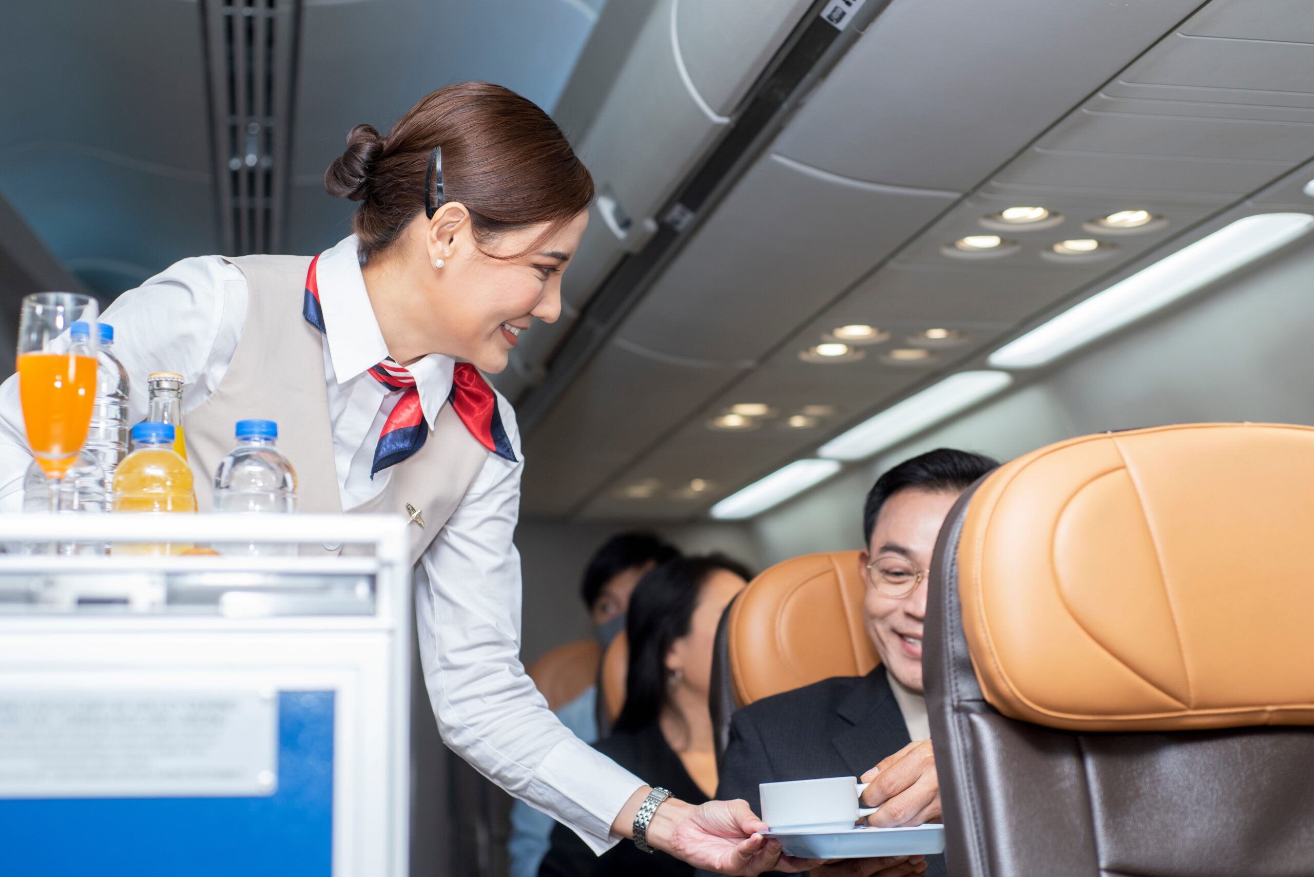 Flight attendants preparing for beverage service