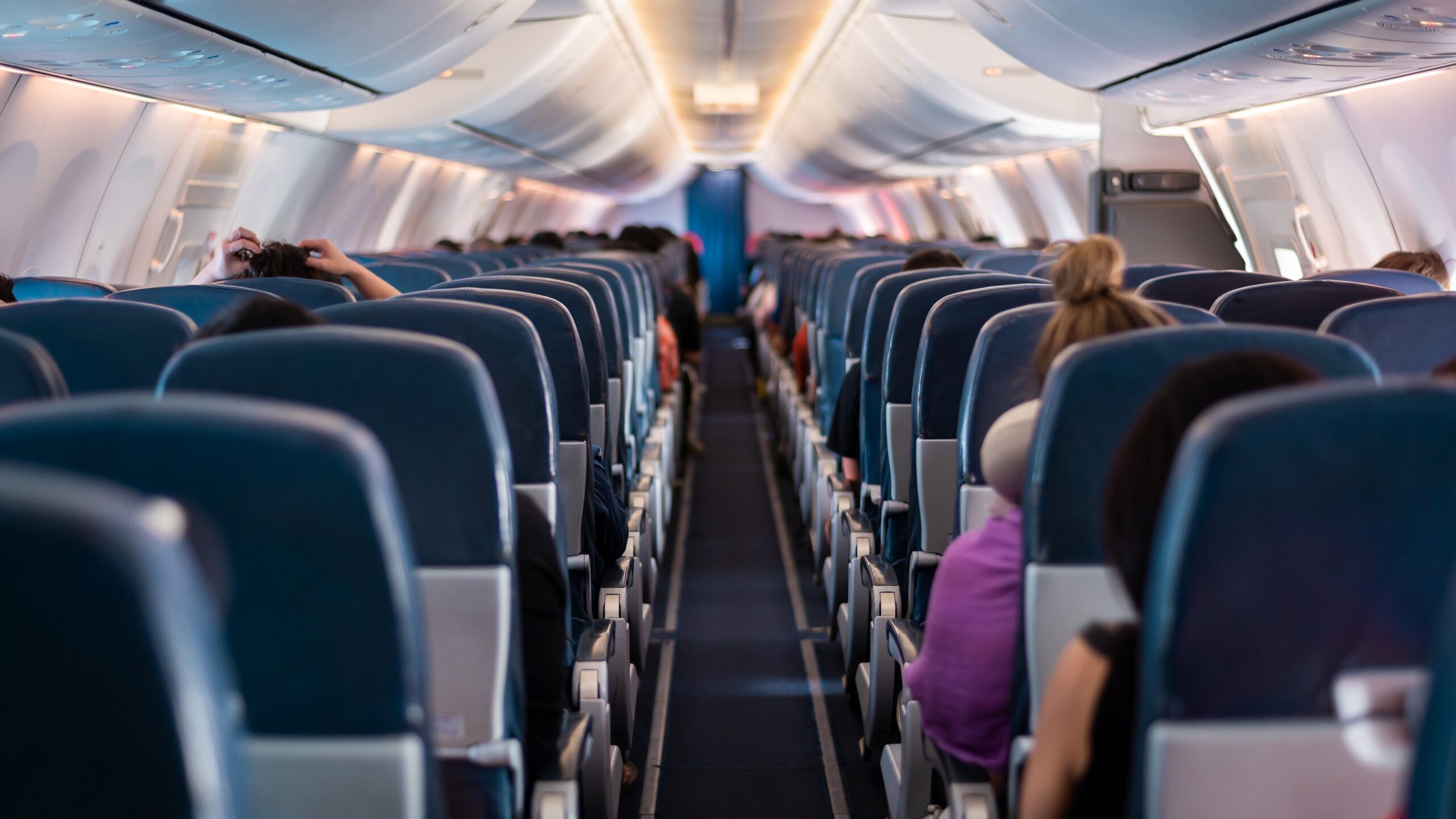 A plane interior with seats, possibly before takeoff