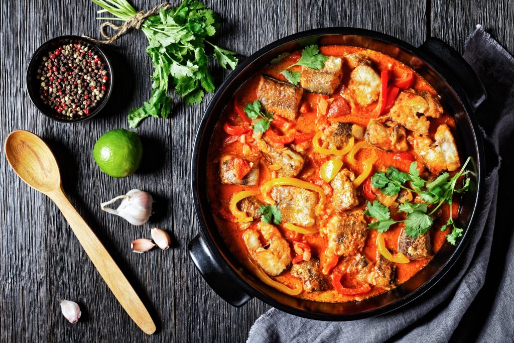 Coq au vin with, mushrooms, onions and bacon in a pot